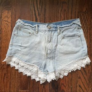 Free people denim shorts with lace trim